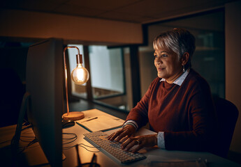 Putting in those overtime hours. Shot of a mature businesswoman working late in an office.