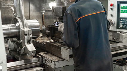 The lathe machine finishing cut the brass shaft parts by lathe tools. The metalworking process by turning machine. Close-u