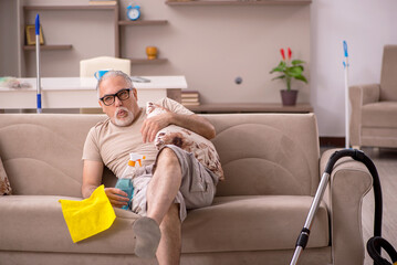 Old man doing housework at home