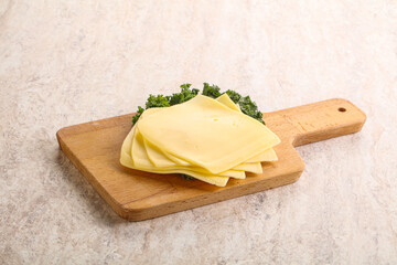 Sliced Gouda cheese over board