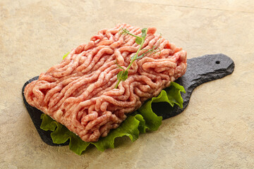 Raw minced pork meat over board