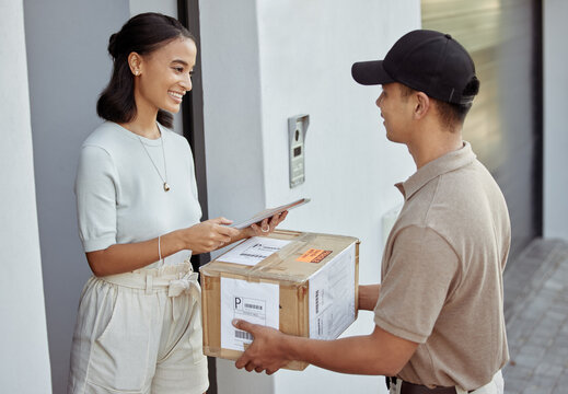 Delivery for you maam. Shot of a young woman signing for an order with a delivery man using a digital tablet.