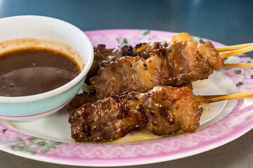 Waki Beef Skewers Grilled on a Charcoal Grill Smells delicious, appetizing, served with hot and spicy dipping sauces.
