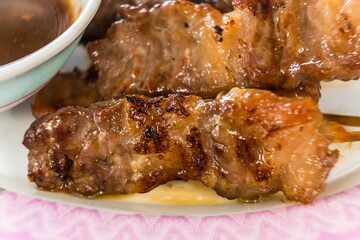 Waki Beef Skewers Grilled on a Charcoal Grill Smells delicious, appetizing, served with hot and spicy dipping sauces.