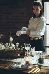 Table setting. A woman decorates the table for the holiday. High quality photo