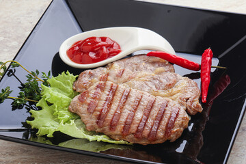 Grilled pork neck steak with ketchup