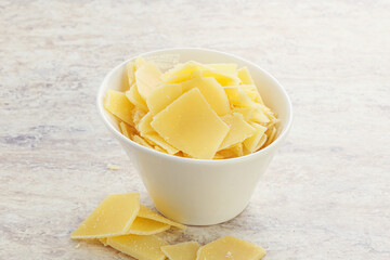 Sliced parmesan cheese heap in the bowl