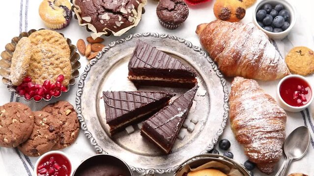 Variety of delicious confectionery products. Top view, rotation. Sweet desserts 
