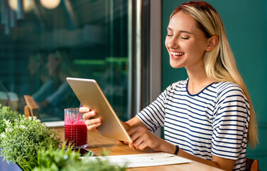 Portrait og happy woman using digital tablet for work, study or social media. People technology