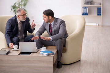 Two businessmen discussing project at workplace