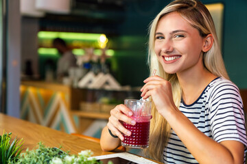 Portrait of beautiful fit woman drinking organic healthy smoothie. People healthy lifestyle concept.