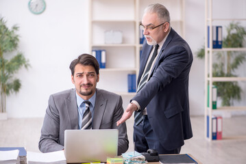 Two male employees in bullying concept