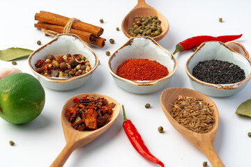 Bowls with various spices on white background