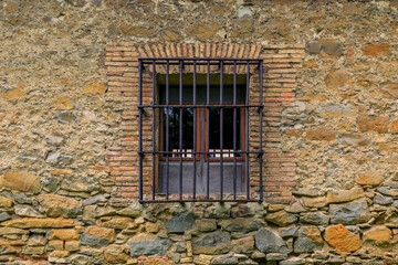 Window of an old stone house in Pamplona Spain, town famous for bull running