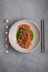 asian noodles with pork and pineapple on gray background 