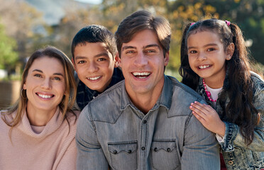 A family blooms with love. Shot of a happy young enjoying spending time together in the park.