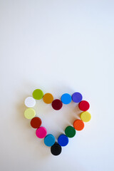 Jars with multi-colored paints in the shape of a heart. Creative background. Paint for drawing. Love postcard. Mock up