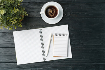 Blank notebook with pen are on top of office desk table