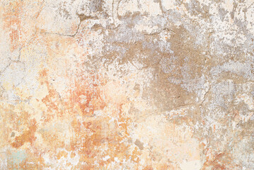 Grunge, rough texture. Uneven concrete wall with peeling, faded old red and yellow paint. Textured background