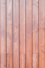 Fototapeta premium Wooden wall made of solid brown planks of wood, vertical fence. Texture background