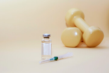 syringe and a jar of liquid stand next to dumbbells on a yellow background, horizontal picture, copy space. the concept of doping in sports, steroids, testosterone and other drugs banned in sports. - obrazy, fototapety, plakaty