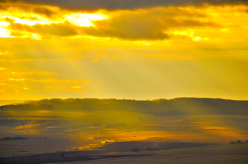 Naklejka premium landscape of the plain from a high point with sunlight in warm colors. The concept of background, wallpaper, paintings, enjoying nature.