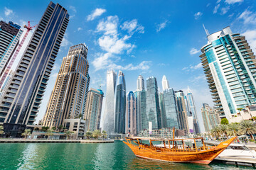 Fototapeta na wymiar Dubai marina and tourist traditional boat in UAE