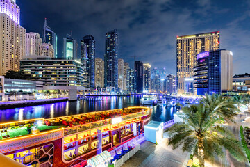 Dubai marina and tourist ship in UAE at night