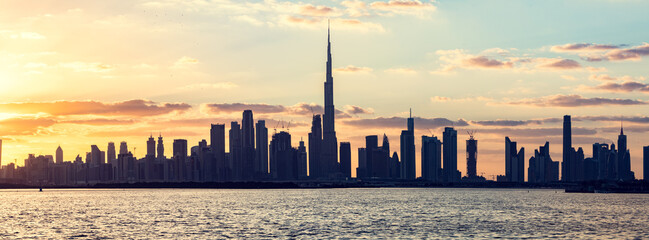 Skyscrapers skyline of Dubai UAE downtown with Burj Khalifa at sunset