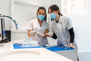 Nurses checking surgical instruments in operating room at hospital