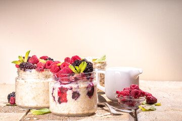Healthy Homemade Overnight Oats Oatmeal with berry. Portioned Oatmeal with fresh raspberry ans blackberry in a glass jar. Healthy summer breakfast