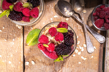 Healthy Homemade Overnight Oats Oatmeal with berry. Portioned Oatmeal with fresh raspberry ans blackberry in a glass jar. Healthy summer breakfast
