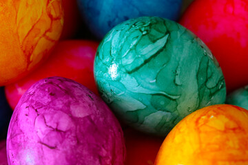 Pascal colorful eggs in a basket, a celebration of spring.