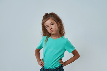 Cropped of serious little girl with hands on hips