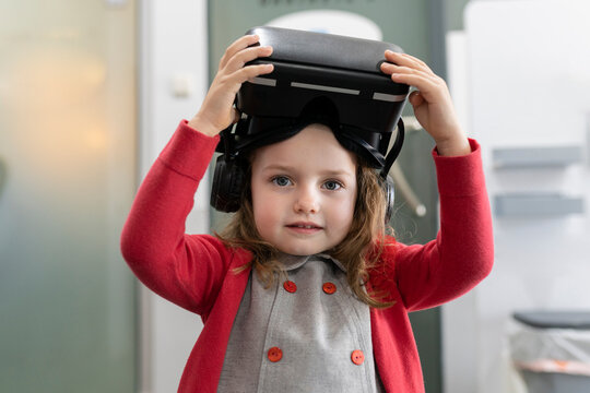 Cute little girl with virtual reality simulator