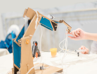 Student child Make Hydraulic Powered Robotic Arm from Cardboard project. Science, Technology,...