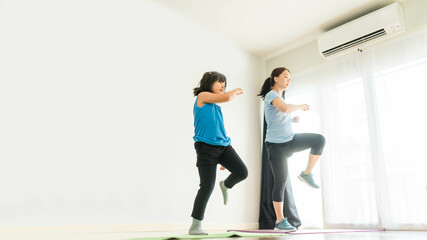 Video streaming.home fitness workout class live streaming online.Asian mother and child girl...