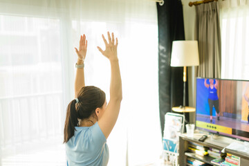 Video streaming Stay home.home fitness workout class live streaming online.Asian woman doing...