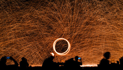 Fire dancers show Swing dancing show fire with flame show on the beach dance man juggling with fire...