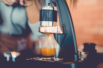 flair espresso.barista making hot espresso shot from flair espresso coffee maker at coffee...