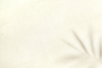 Background of light beach sand with space for text.