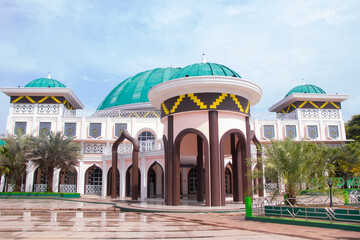 Front corner view of the taqwa mosque in Metro, Lampung, Indonesia. bright blue sky background....
