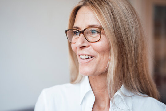 Smiling mature woman with eyeglasses at work place