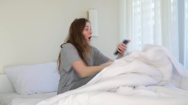 Overslept. Late for work. woman woke up late. not hear alarm. ran out of bed. Lazy morning. wake up after night sleep on bed in bedroom and hold alarm clock. Late facial expressions, free space