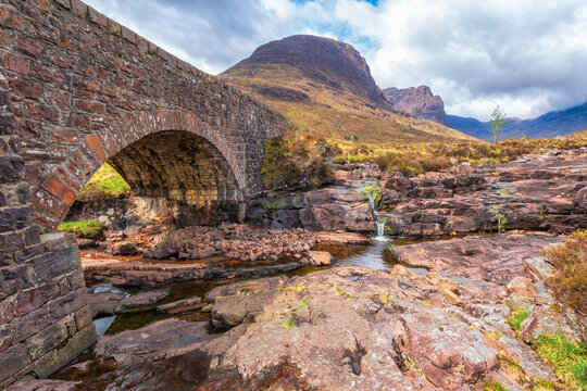 Stone bridge over Russel Burn stream by mountains