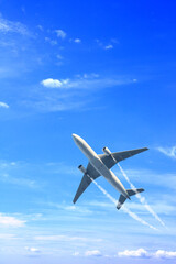 Vertical nature background with aircraft and Jet trailing smoke in the sky. Airplane and condensation trail