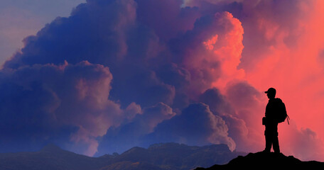 Success achievement concept. Silhouette of person standing on top of mountain.