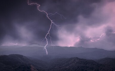 mountains and dark clouds with thunderstorm and lightening.
