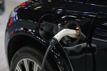 The power supply connects to electric vehicles to charge batteries, charging industrial transport technology, which is the future of EV vehicles. Fuel is plugged into a hybrid vehicle. at the launch e