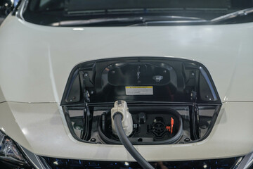 The power supply connects to electric vehicles to charge batteries, charging industrial transport technology, which is the future of EV vehicles. Fuel is plugged into a hybrid vehicle. at the launch e